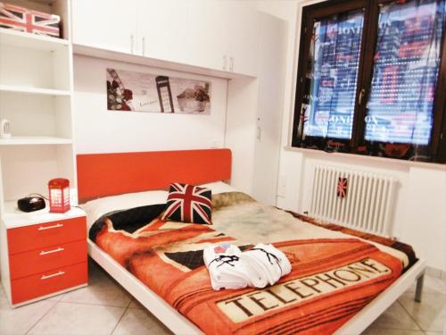 a bedroom with a bed and a window and a tv at LONDON BY SEA in Porto Recanati