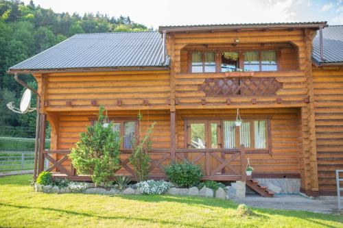 a log cabin with a large window at Lucy in Yaremche