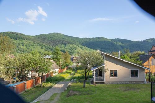 a view of a small house in a village with mountains at Lucy in Yaremche