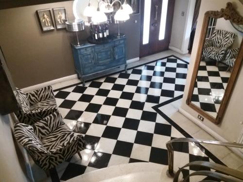 a bathroom with a black and white checkered floor at Mito Casa Hotel in Santiago