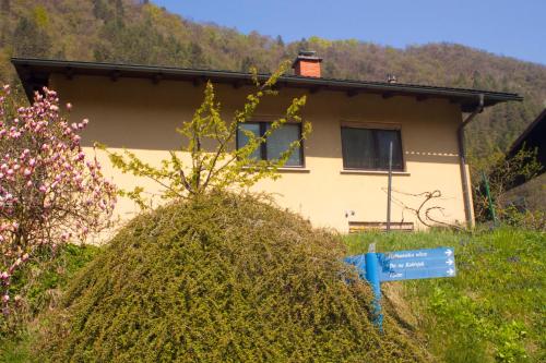 a small house with a sign in front of it at Na Kopitarjevi in Laško