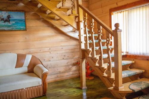 a wooden staircase in a cabin with a stair case at Lucy in Yaremche