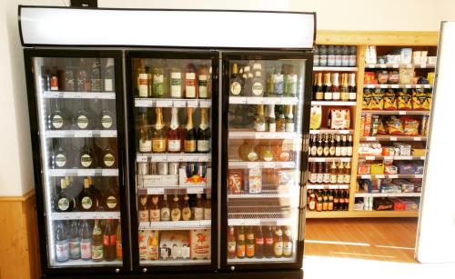 a refrigerator filled with lots of different types of alcohol at Hotel Demling in Randersacker