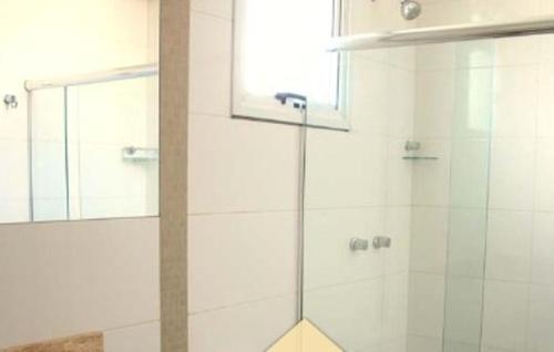 a shower with a glass door in a bathroom at Hotel Jacuí in Cachoeira do Sul