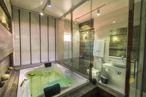 uma grande casa de banho com banheira e lavatório em Cristal Pousada em Morro de São Paulo