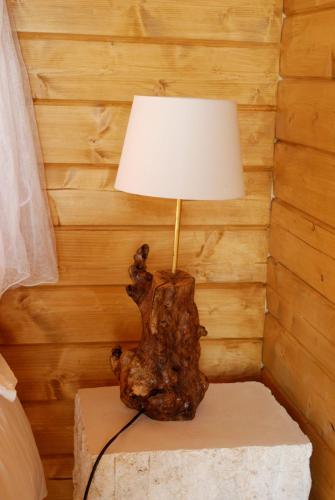 a lamp sitting on a table in a bedroom at Ecolodge Langhe in Cherasco