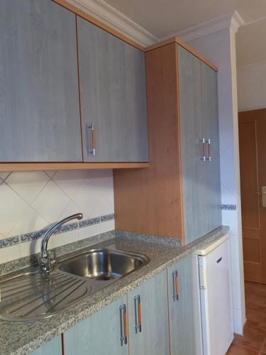 a kitchen with a sink and wooden cabinets at Altura Beach AL in Altura