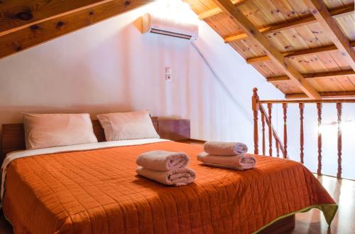 a bedroom with a bed with towels on it at Irides Apartments in Megalochori
