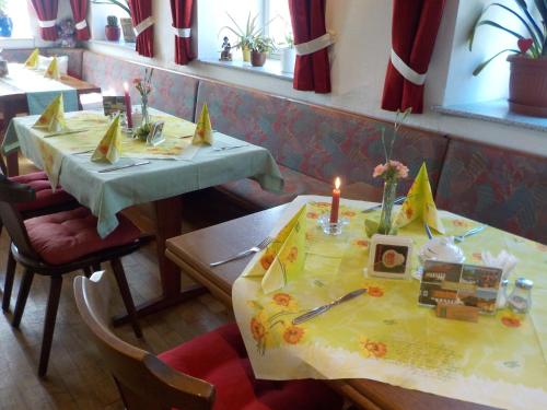 two tables in a restaurant with a candle on them at Gasthaus Zehrermühle in Schönberg