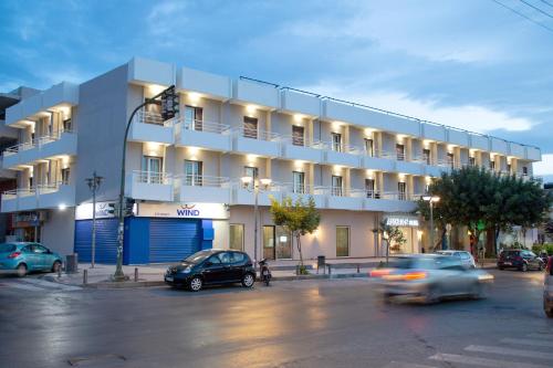 a building with cars parked in front of it at Asterion Hotel in Heraklio Town