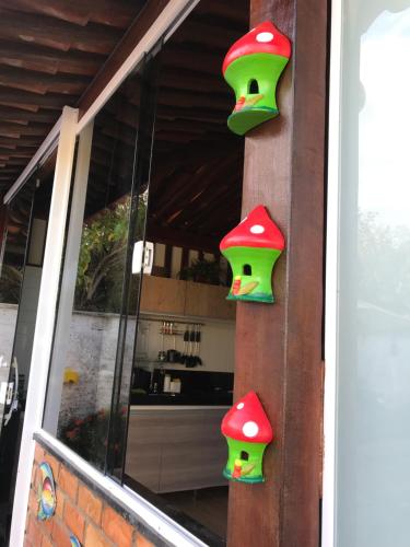 a pair of door handles on a house with mushrooms at Chalé Temporada Porto dos Lençóis - Lençóis Maranhenses in Barreirinhas