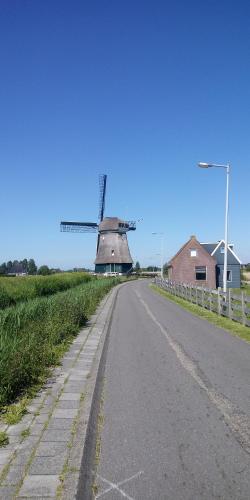 a windmill sitting on the side of a road at Noemie's Pension House in Volendam