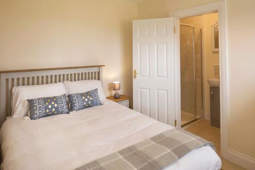 a bedroom with a white bed with pillows on it at Oakwell holiday village in Ramelton