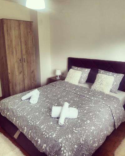 a bedroom with a bed with two towels on it at Apartman KEJ in Pirot