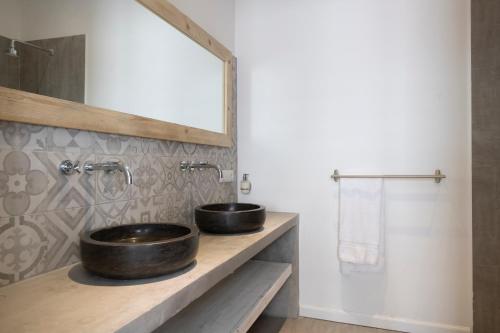a bathroom with two sinks and a mirror at BOHO Bohemian Boutique Hotel in Willemstad