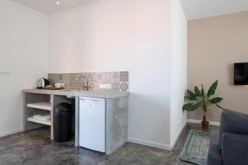 a kitchen with a counter and a sink in a room at BOHO Bohemian Boutique Hotel in Willemstad