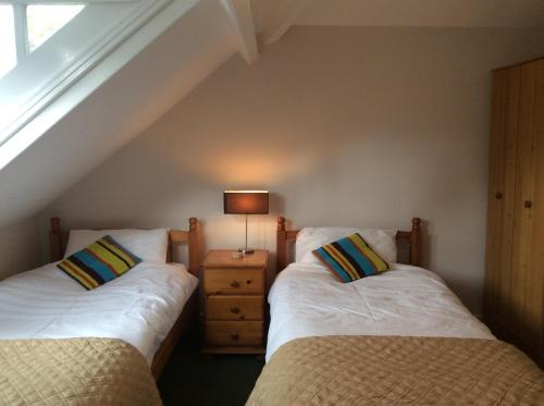 two twin beds in a room with a window at Highgate, Beverley/Hull in Beverley