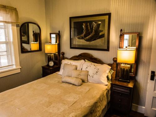 a bedroom with a bed with two lamps on it at Nolichuckey Bluffs Bed & Breakfast Cabins in Greeneville