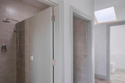 a bathroom with a shower with a glass door at Oakwell holiday village in Ramelton