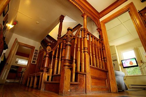 an ornate wooden staircase in a house at Auberge Internationale de Rivière-du-Loup O76381 in Rivière-du-Loup