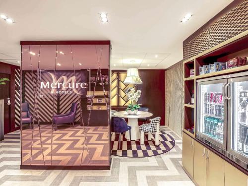 a store with a table and chairs in a room at Mercure Paris Arc de Triomphe Etoile in Paris