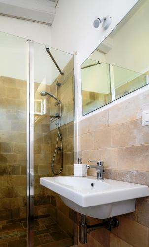 a bathroom with a sink and a shower at Masseria Montefieno in Castellana Grotte