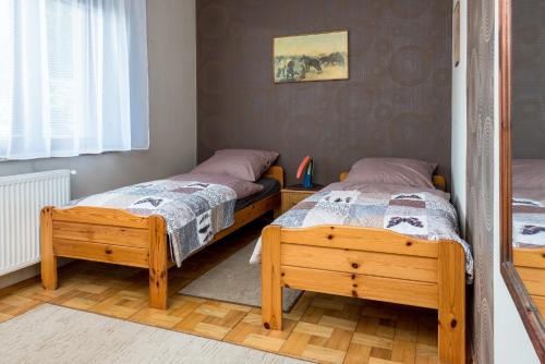 a bedroom with two beds and a window at Między Zdrojami in Rymanów