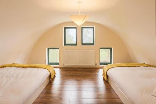 two beds in a attic room with windows at Oakwell holiday village in Ramelton
