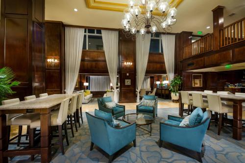 
a living room filled with furniture and tables at The Shores Resort & Spa in Daytona Beach
