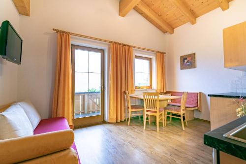 a living room with a table and a dining room at Landhaus Sonnblick in Zellberg