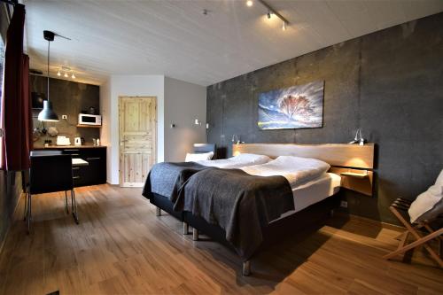 a bedroom with a large bed and a kitchen at The Potato Storage in Svínafell