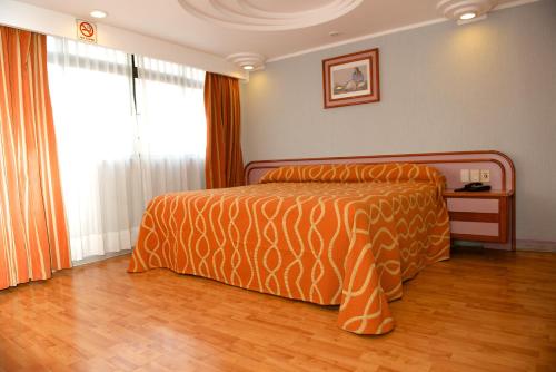 Ein Bett oder Betten in einem Zimmer der Unterkunft Hotel Cuba