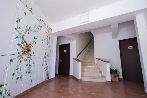 a hallway with stairs and a painting on the wall at Hadass Desert Inn in Dimona