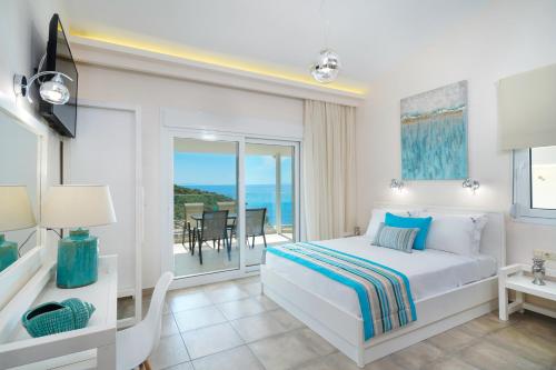 a bedroom with a bed and a view of the ocean at ATSPAS VIEW in Skala Marion
