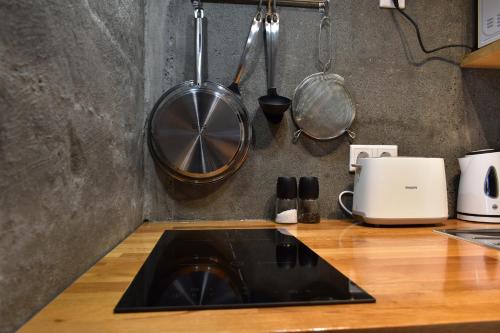 a kitchen counter with a sink and a stove at The Potato Storage in Svínafell