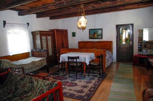 a living room with a table and a bedroom at Vén Diófa Kúria in Balaton