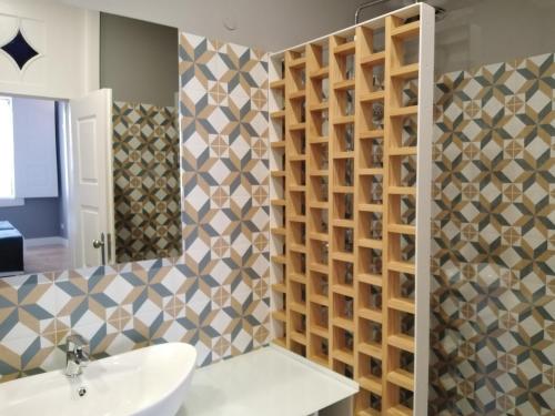 a bathroom with a sink and a mirror at ALM SANTA LUZIA in Guimarães