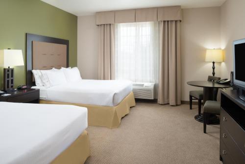 a hotel room with two beds and a television at Holiday Inn Express Hotel & Suites North Sequim by IHG in Sequim