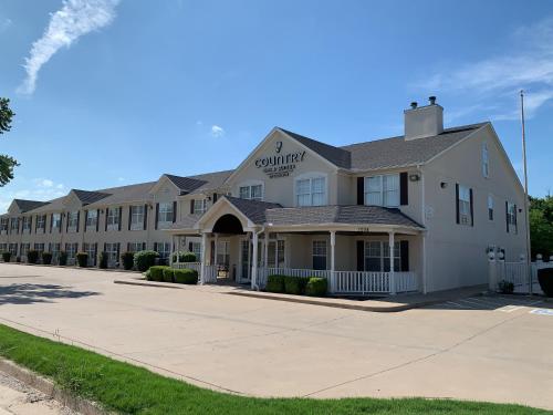 a large white building with a sign on it at Country Inn & Suites by Radisson, Tulsa, OK in Tulsa
