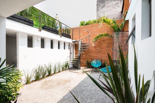a courtyard of a house with a staircase and plants at JUUB New Beautiful Suite Nuevo Polanco (R2) in Mexico City