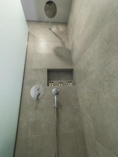 a bathroom with a shower with a shower head at Paradise Resort in Finikounta