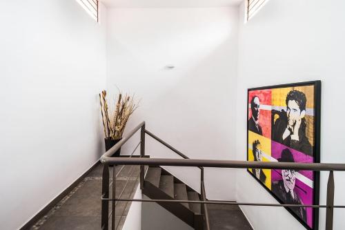 a hallway with a staircase with a painting on the wall at JUUB In the Heart of New Polanco (R4) in Mexico City