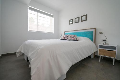 a white bedroom with a large bed and a window at JUUB In the Heart of New Polanco (R4) in Mexico City