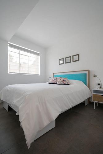 a white bedroom with a large bed and a window at JUUB In the Heart of New Polanco (R4) in Mexico City