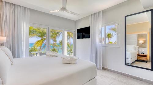 a bedroom with a large bed with a view of the ocean at Senator Puerto Plata in San Felipe de Puerto Plata