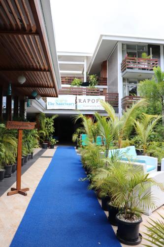 a blue carpet in front of a building with plants at The Sanctuary Hotel Resort Spa in Port Moresby