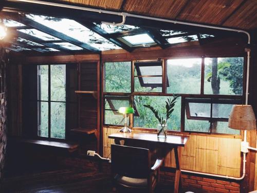 a room with a desk and windows in a room at Monsamkien Farmstay in Phayao