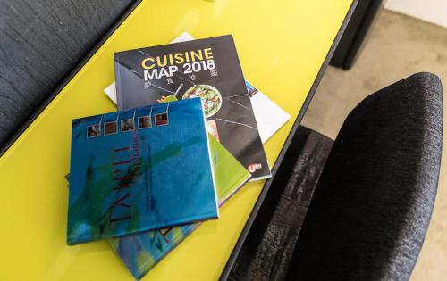 a table with some pamphlets on top at Vendome East Inn in Taipei