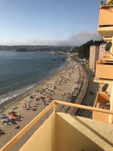 a view of a beach with crowds of people at Depto. frente al mar in Tomé