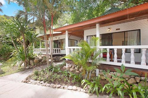 a house with a porch and palm trees at Crystal Bay Yacht Club Beach Resort in Lamai